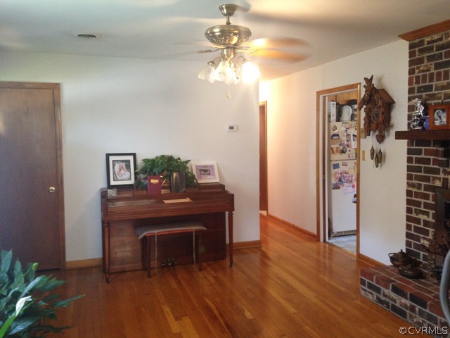 915 Yorkshire Road Colonial Heights, VA 23834 - Photo 6 of 13 a view of a hallway with wooden floor and a fireplace