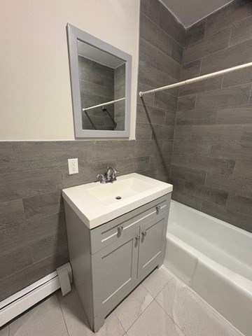 100 Prospect Street, Unit 1 Waltham, MA 02453 - Photo 11 of 12 a bathroom with a sink and a bathtub