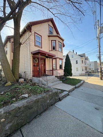100 Prospect Street, Unit 1 Waltham, MA 02453 - Photo 12 of 12 a front view of a house with a yard