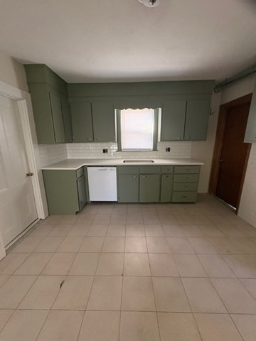 100 Prospect Street, Unit 1 Waltham, MA 02453 - Photo 2 of 12 a room with furniture a window and kitchen view