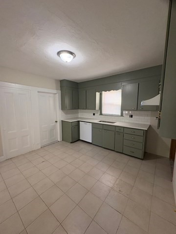 100 Prospect Street, Unit 1 Waltham, MA 02453 - Photo 3 of 12 a room with a cabinets and sink