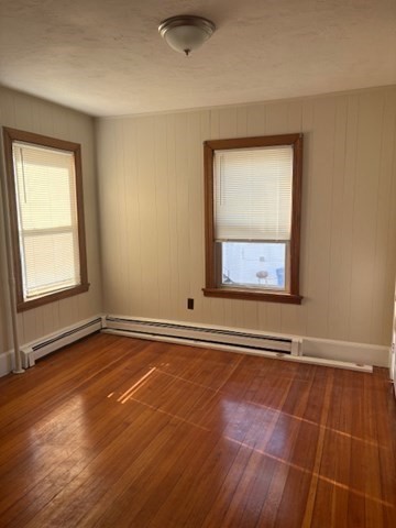 100 Prospect Street, Unit 1 Waltham, MA 02453 - Photo 5 of 12 an empty room with wooden floor and windows