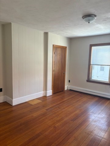 100 Prospect Street, Unit 1 Waltham, MA 02453 - Photo 6 of 12 a view of an empty room with wooden floor and a window