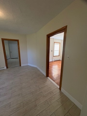 100 Prospect Street, Unit 1 Waltham, MA 02453 - Photo 9 of 12 a view of hallway with wooden floor