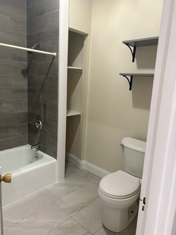 100 Prospect Street, Unit 1 Waltham, MA 02453 - Photo 10 of 12 a bathroom with a toilet and a tub