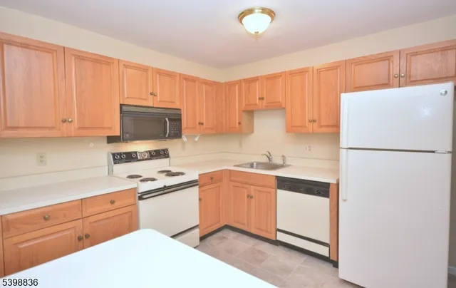 a kitchen with stainless steel appliances a sink and a refrigerator