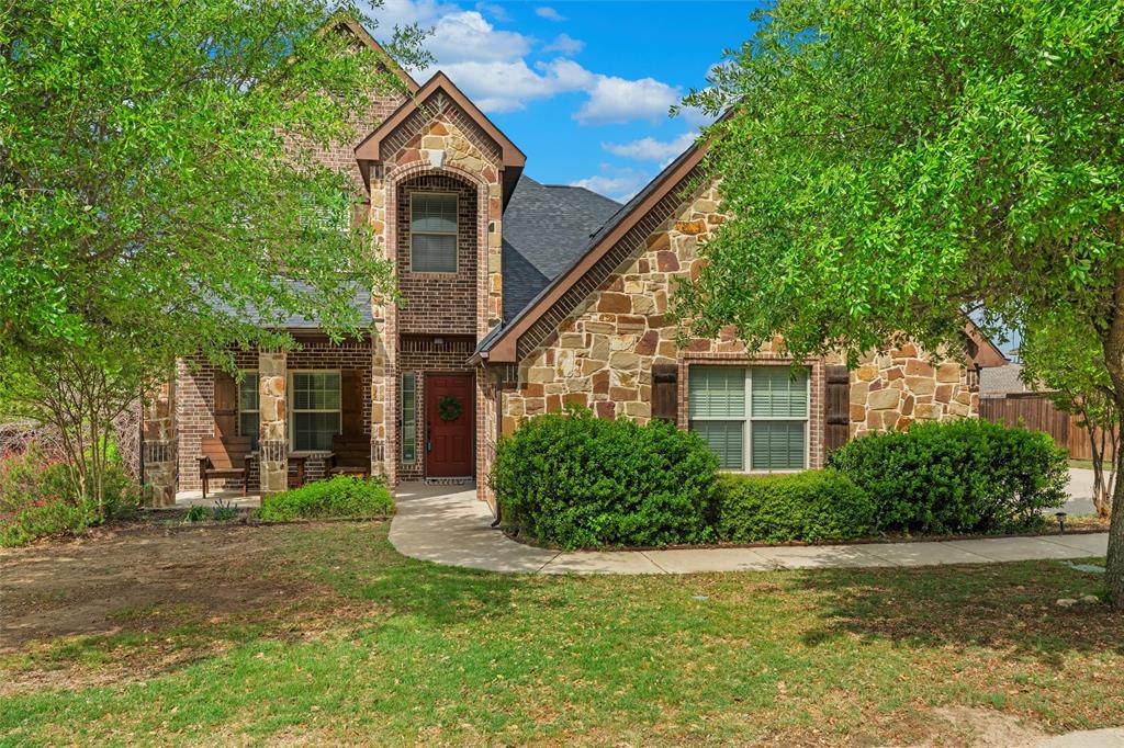 2322 Trace Ridge Drive Weatherford, TX 76087 - Photo 1 of 1 View of front of house featuring a front yard, stone siding, and brick
