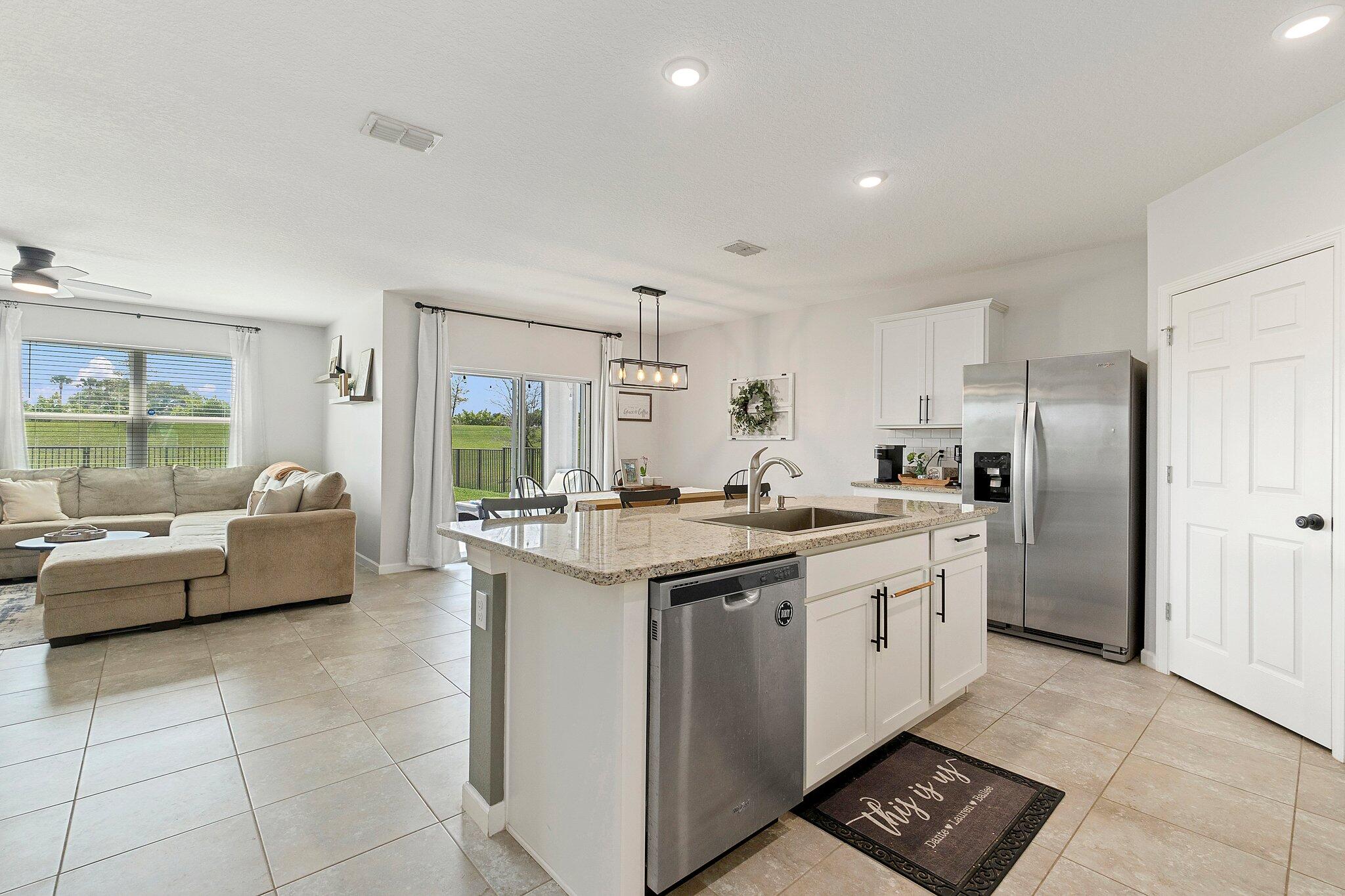 10850 Pacini Way Port St. Lucie, FL 34987 - Photo 11 of 36 a kitchen with a sink stove and refrigerator