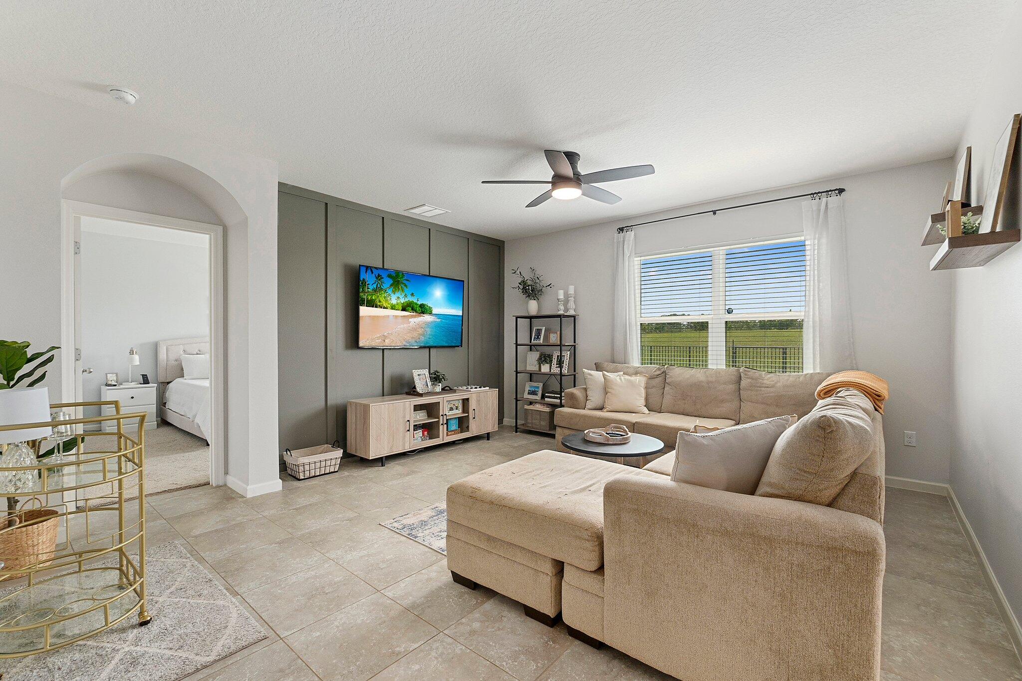 10850 Pacini Way Port St. Lucie, FL 34987 - Photo 13 of 36 a living room with furniture and a flat screen tv