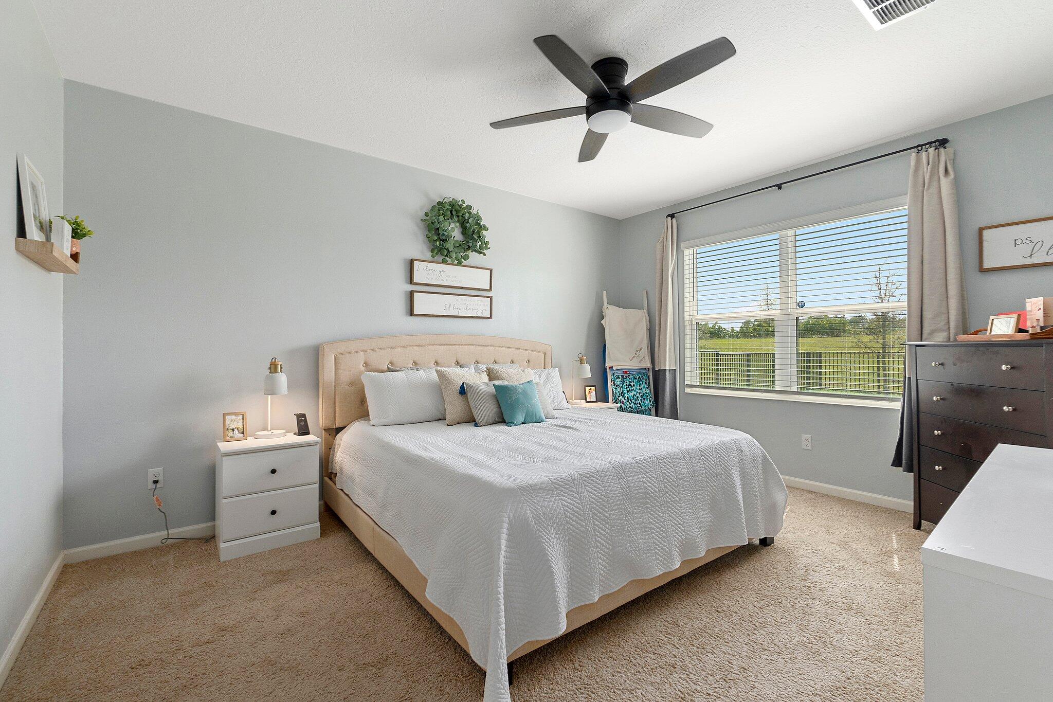 10850 Pacini Way Port St. Lucie, FL 34987 - Photo 15 of 36 a spacious bedroom with a large bed and a window