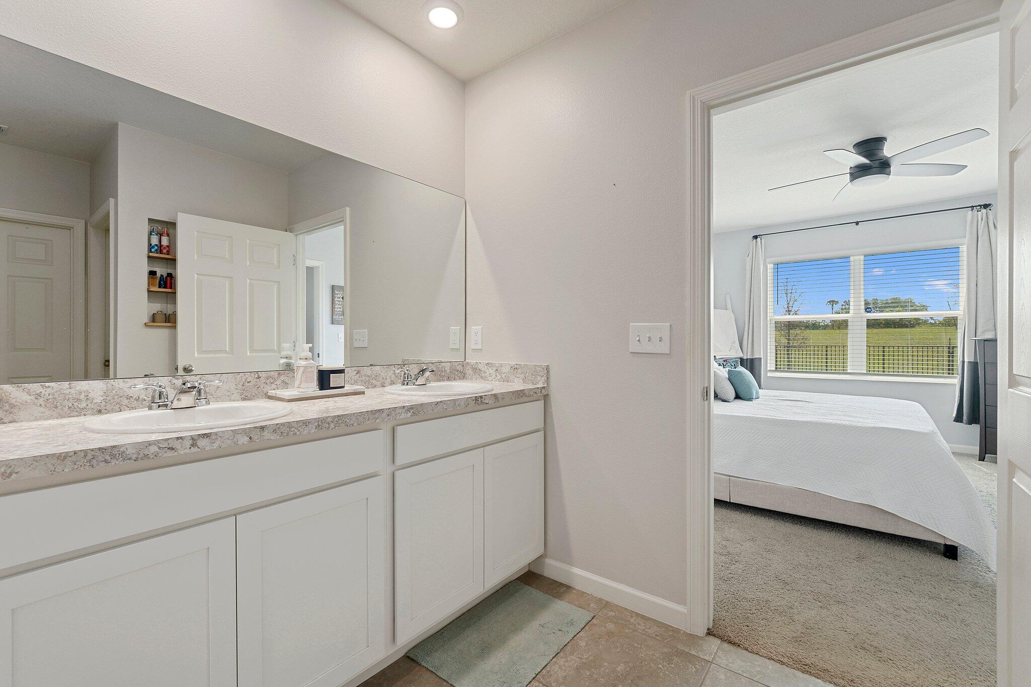10850 Pacini Way Port St. Lucie, FL 34987 - Photo 18 of 36 a bathroom with a double vanity sink and a bathtub