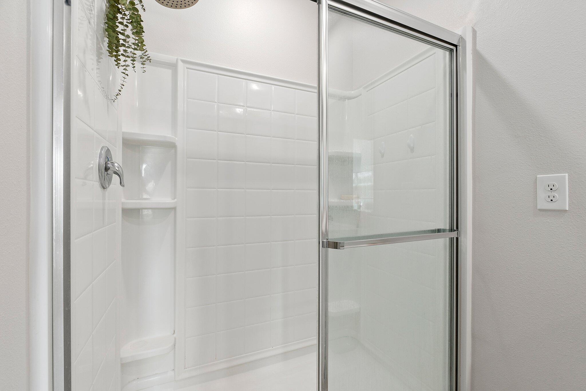 10850 Pacini Way Port St. Lucie, FL 34987 - Photo 19 of 36 a bathroom with a glass shower door