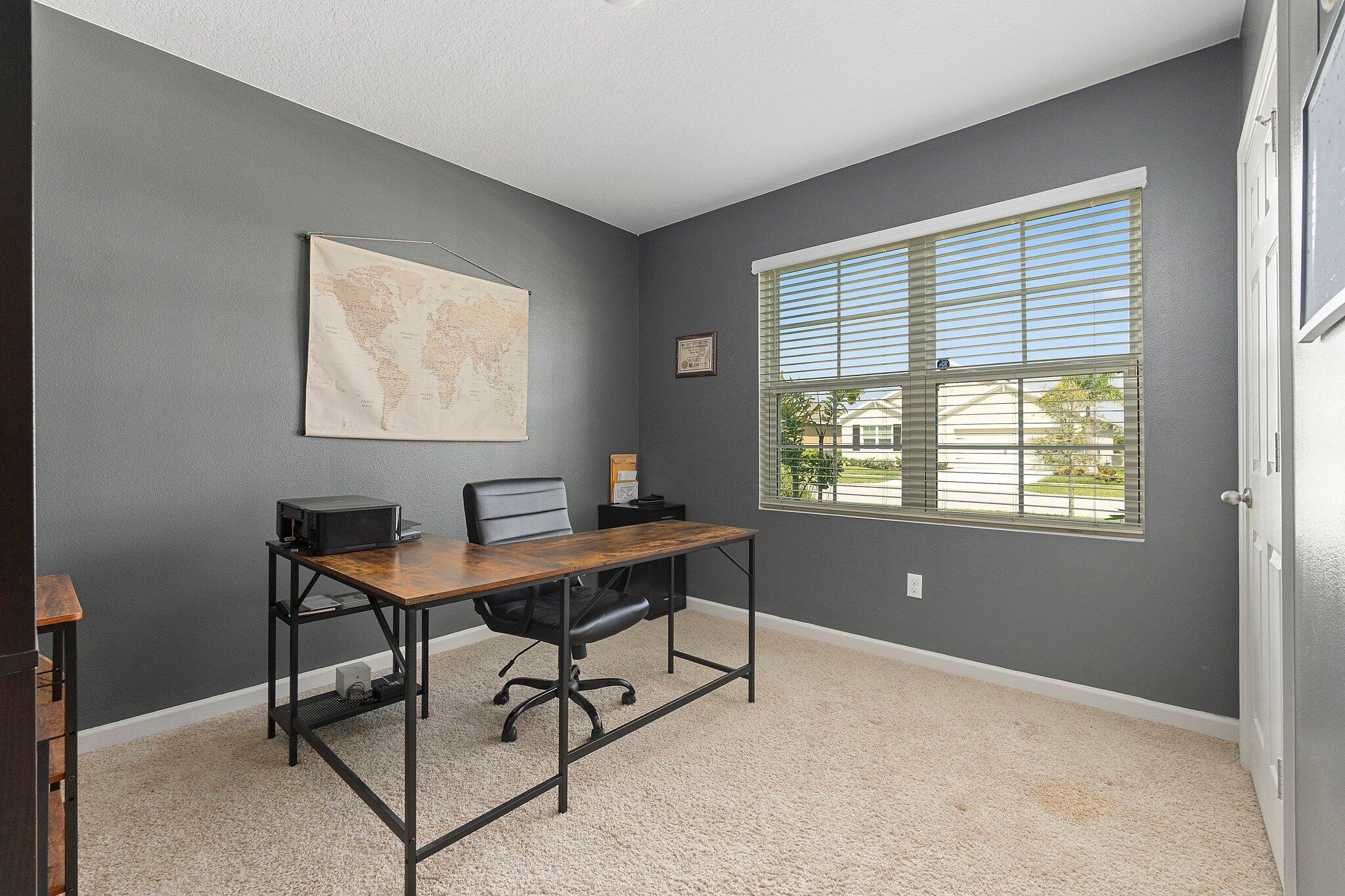 10850 Pacini Way Port St. Lucie, FL 34987 - Photo 21 of 36 a view of a workspace with furniture and a window