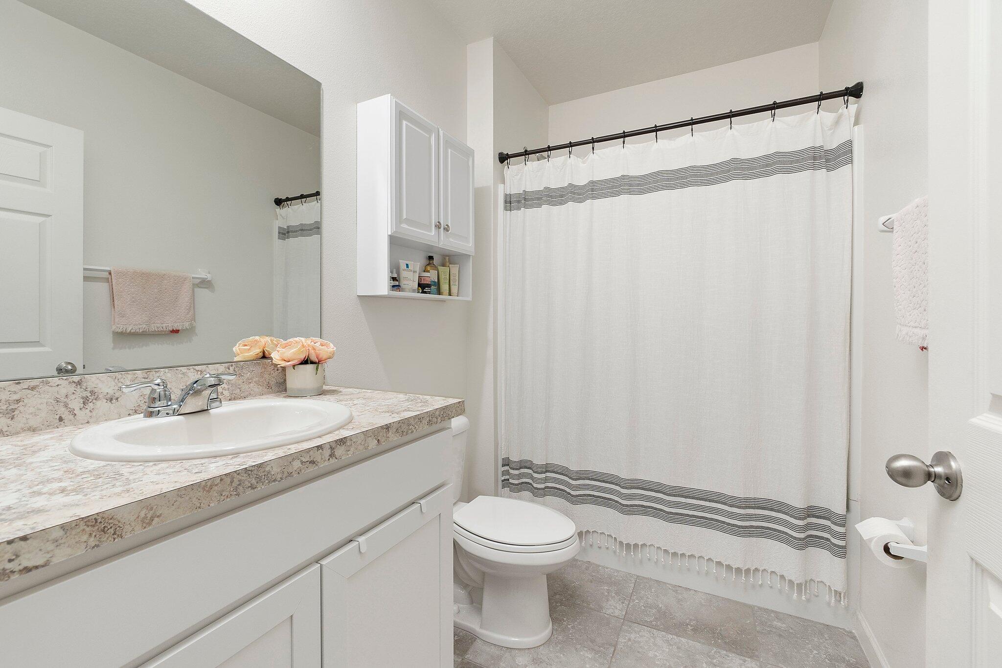 10850 Pacini Way Port St. Lucie, FL 34987 - Photo 22 of 36 a bathroom with a granite countertop sink toilet and shower