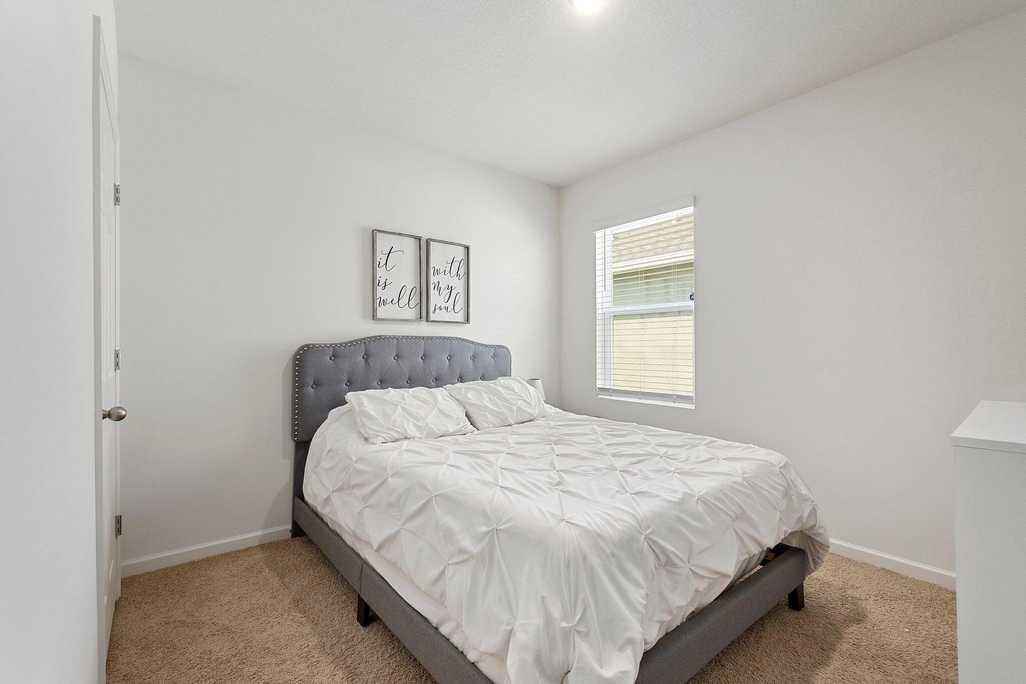 10850 Pacini Way Port St. Lucie, FL 34987 - Photo 24 of 36 a bedroom with a bed and a window