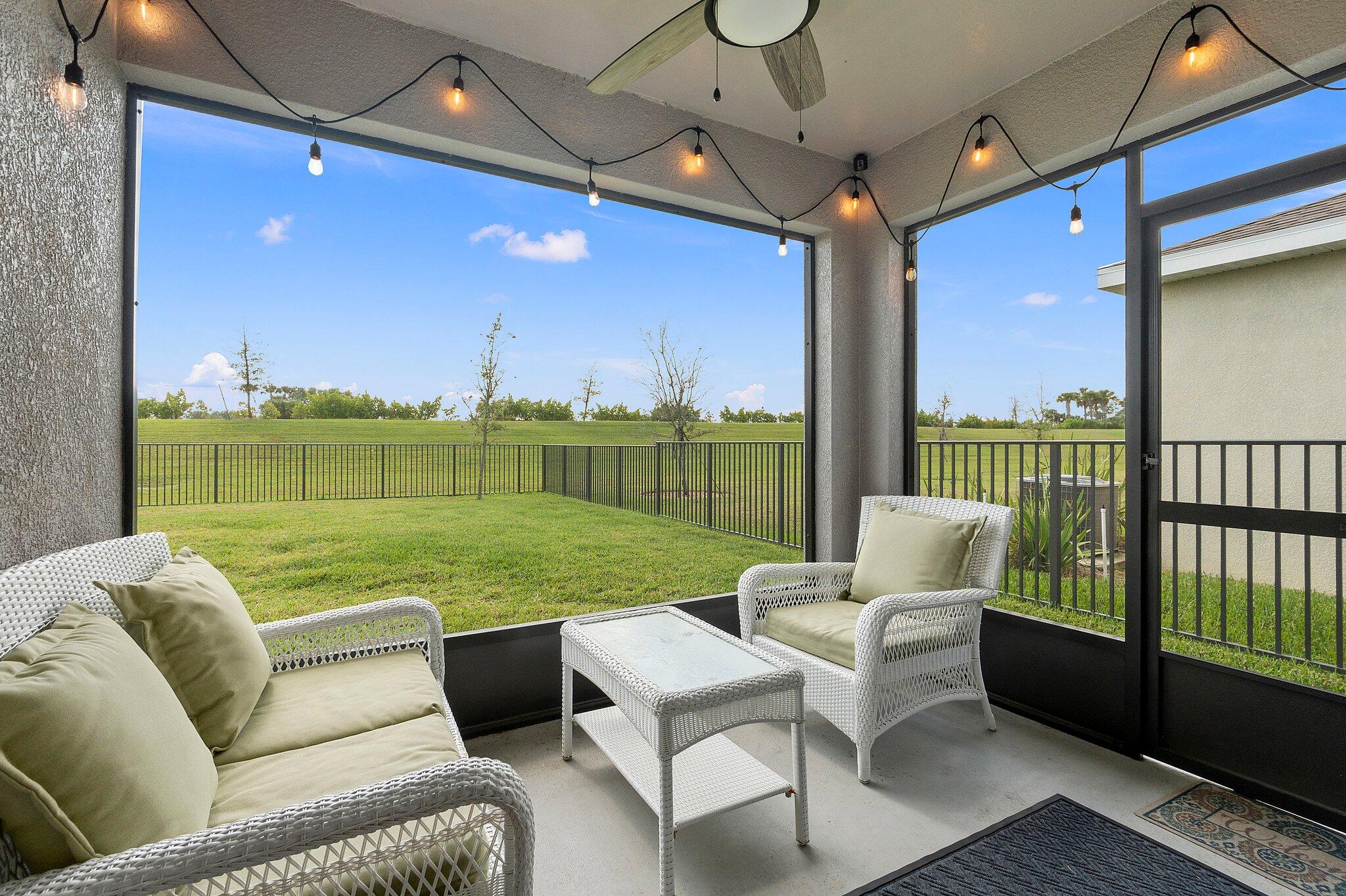 10850 Pacini Way Port St. Lucie, FL 34987 - Photo 27 of 36 a balcony with furniture and a garden