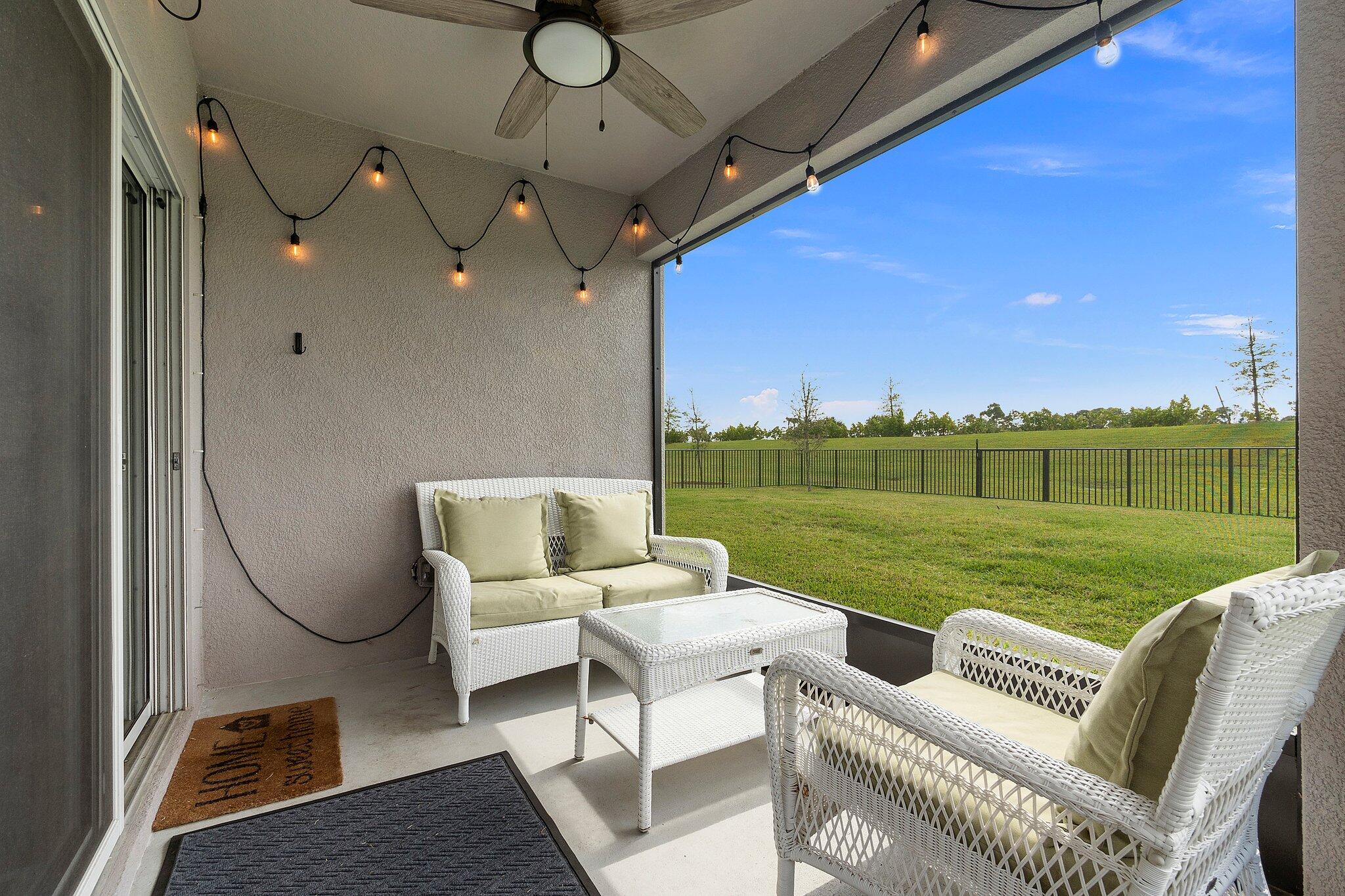10850 Pacini Way Port St. Lucie, FL 34987 - Photo 28 of 36 a view of a swimming pool and lounge chairs in back of a house