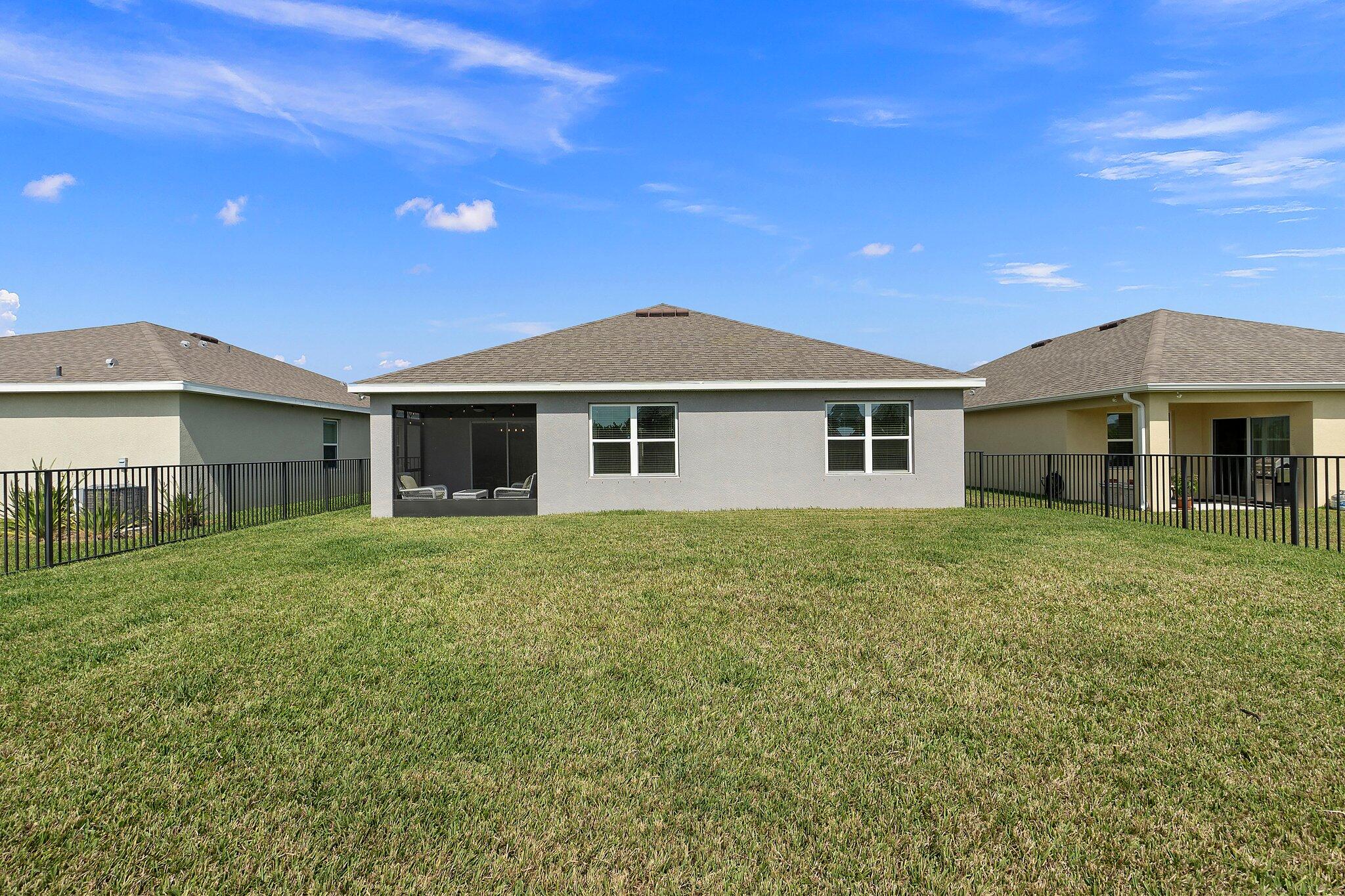 10850 Pacini Way Port St. Lucie, FL 34987 - Photo 30 of 36 a front view of a house with a garden