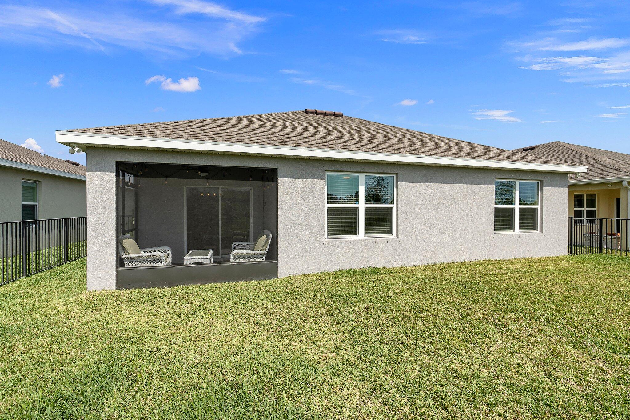 10850 Pacini Way Port St. Lucie, FL 34987 - Photo 31 of 36 a front view of a house with a yard