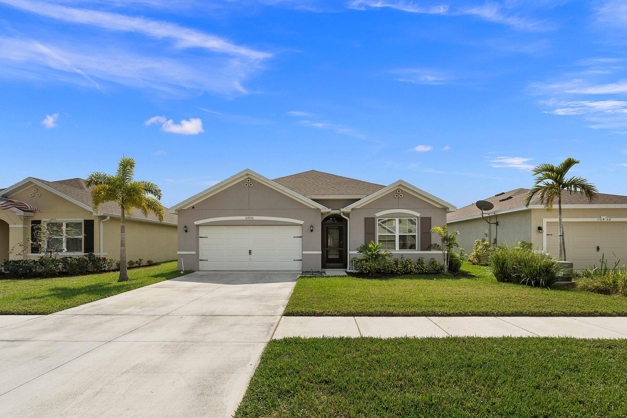 10850 Pacini Way Port St. Lucie, FL 34987 - Photo 5 of 36 a view of house with a big yard plants and large trees