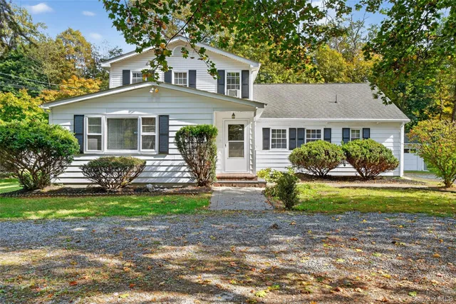 a front view of a house with a garden and porch