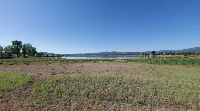 a view of a green field with an outdoor space