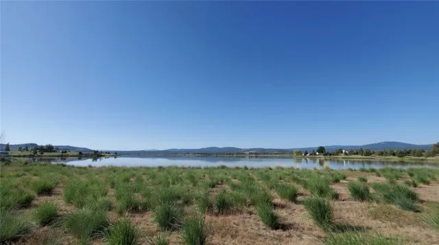 a view of a lake with houses in the background