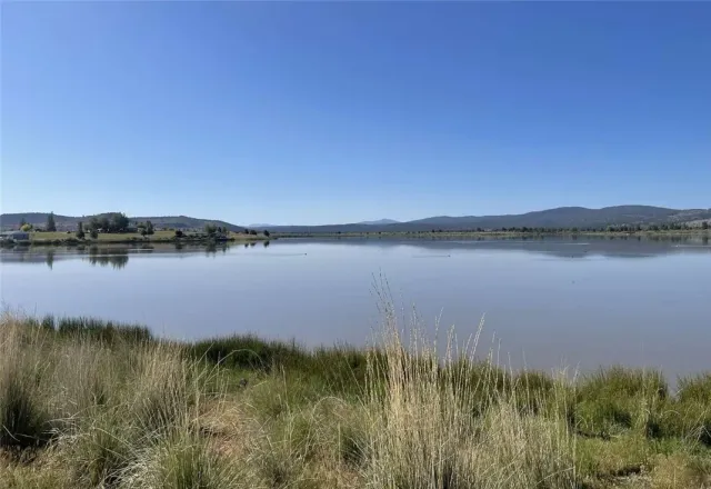 a view of a lake with houses in the back