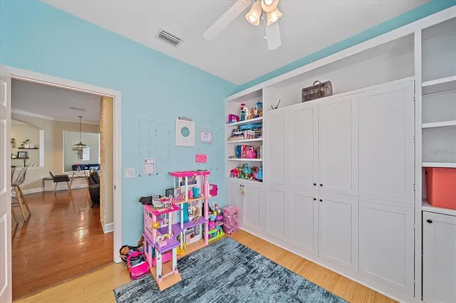 a view of play room with furniture and wooden floor