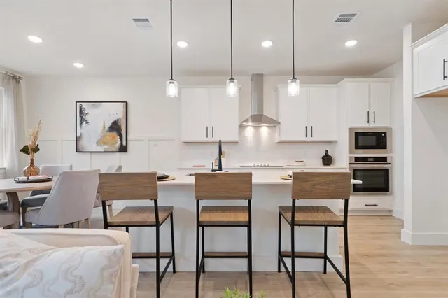 a dining room with furniture and wooden floor