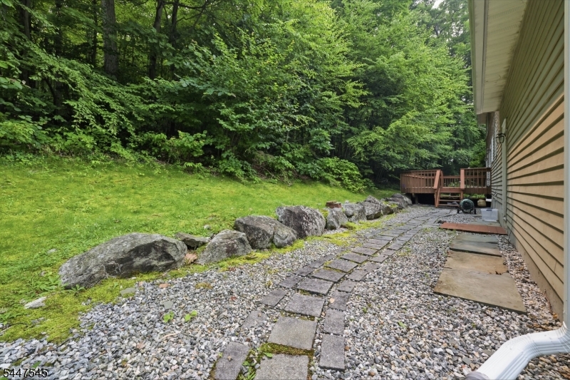 860 Glen Road Sparta, NJ 07871 - Photo 39 of 43 a view of a backyard with plants and a bench