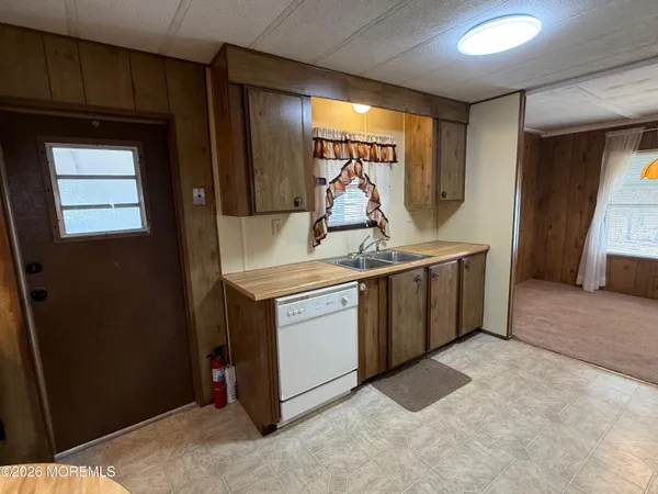 a white refrigerator freezer and a stove sitting inside of a kitchen