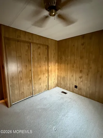 an empty room with windows and closet