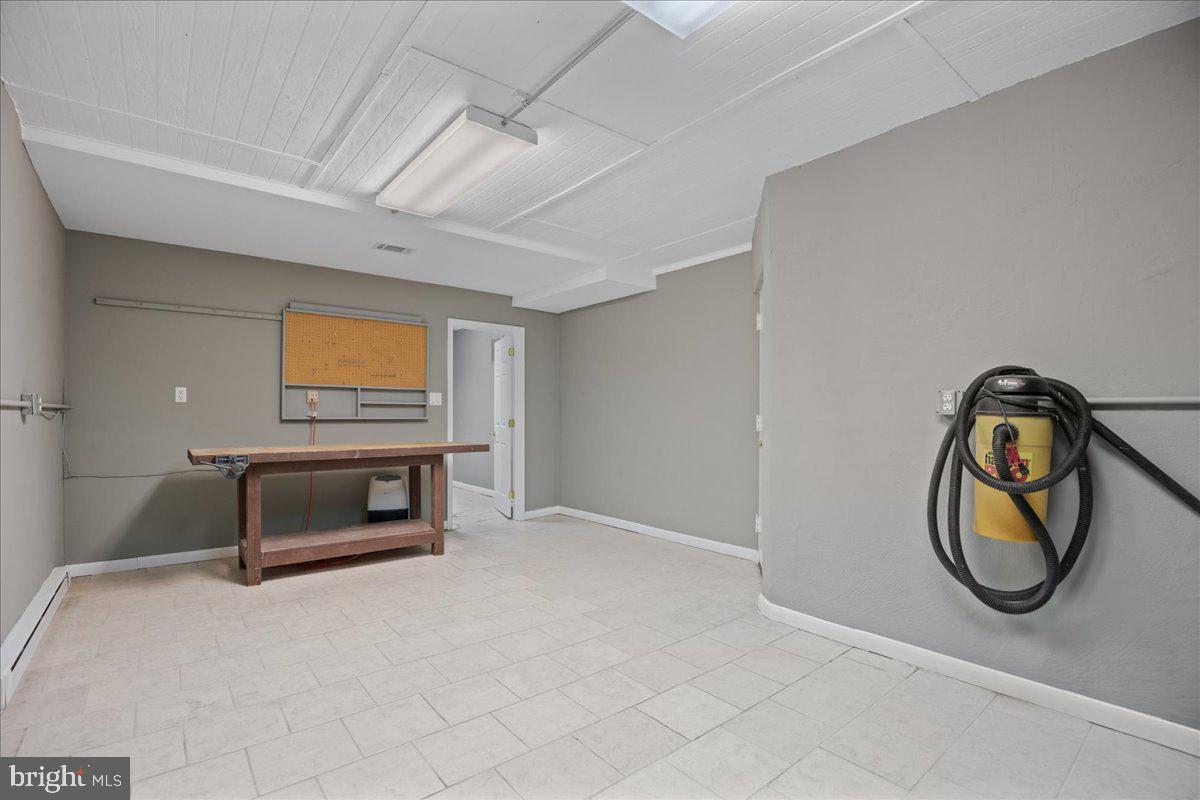 8438 Mackall Road St. Leonard, MD 20685 - Photo 55 of 68 Lower level with tile flooring