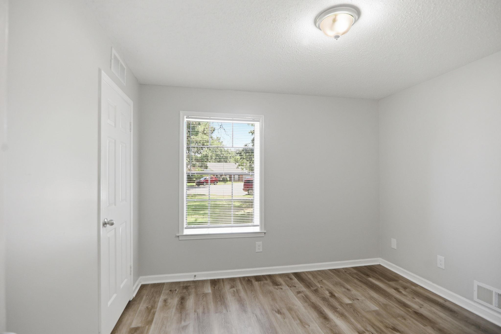 3113 Raleigh Ridge Cove Memphis, TN 38128 - Photo 17 of 38 Room featuring wood-finish flooring, white walls, and a window with blinds