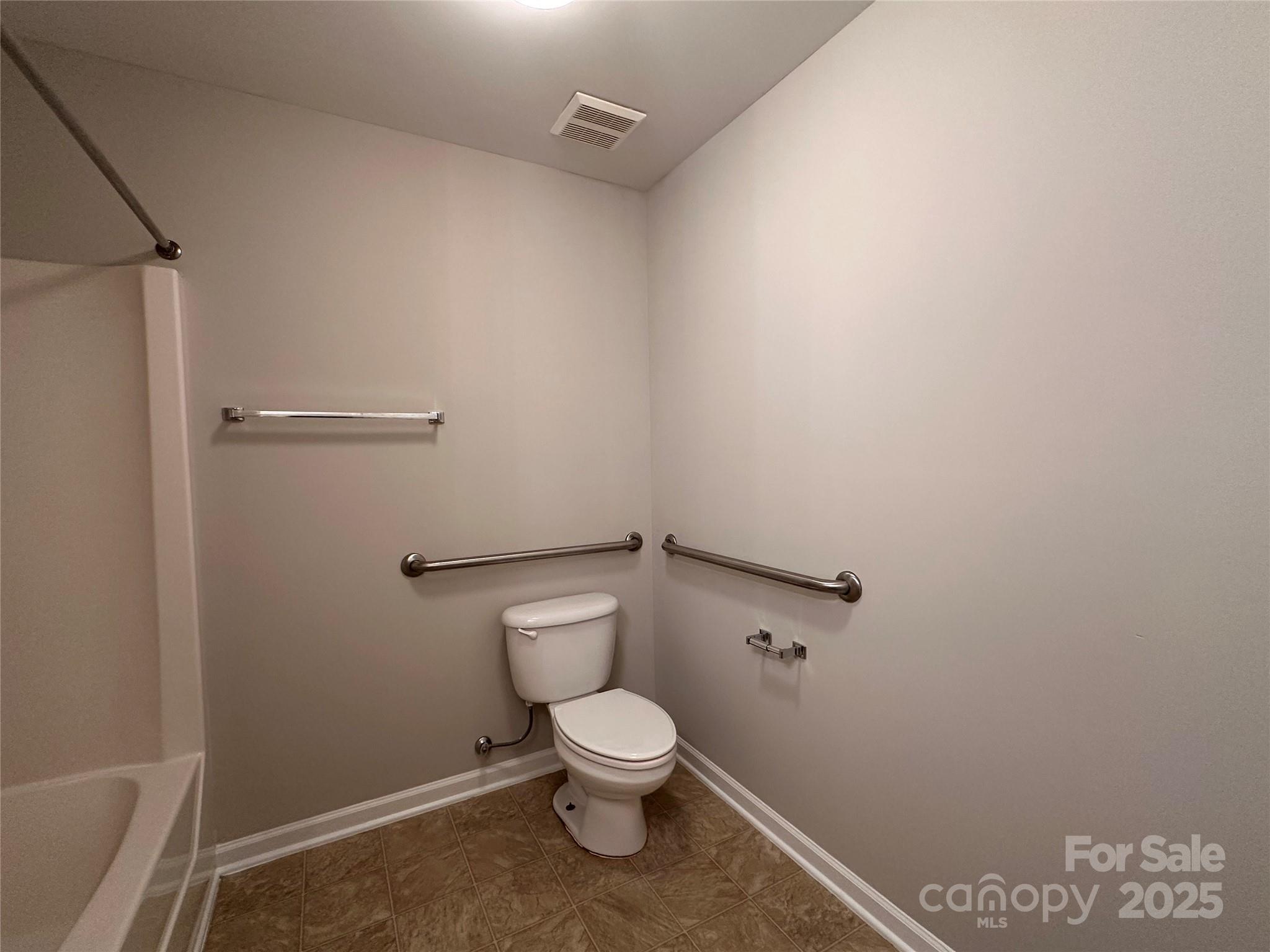 5236 Hilltop Road Jamestown, NC 27282 - Photo 21 of 27 a white toilet sitting next to a shower