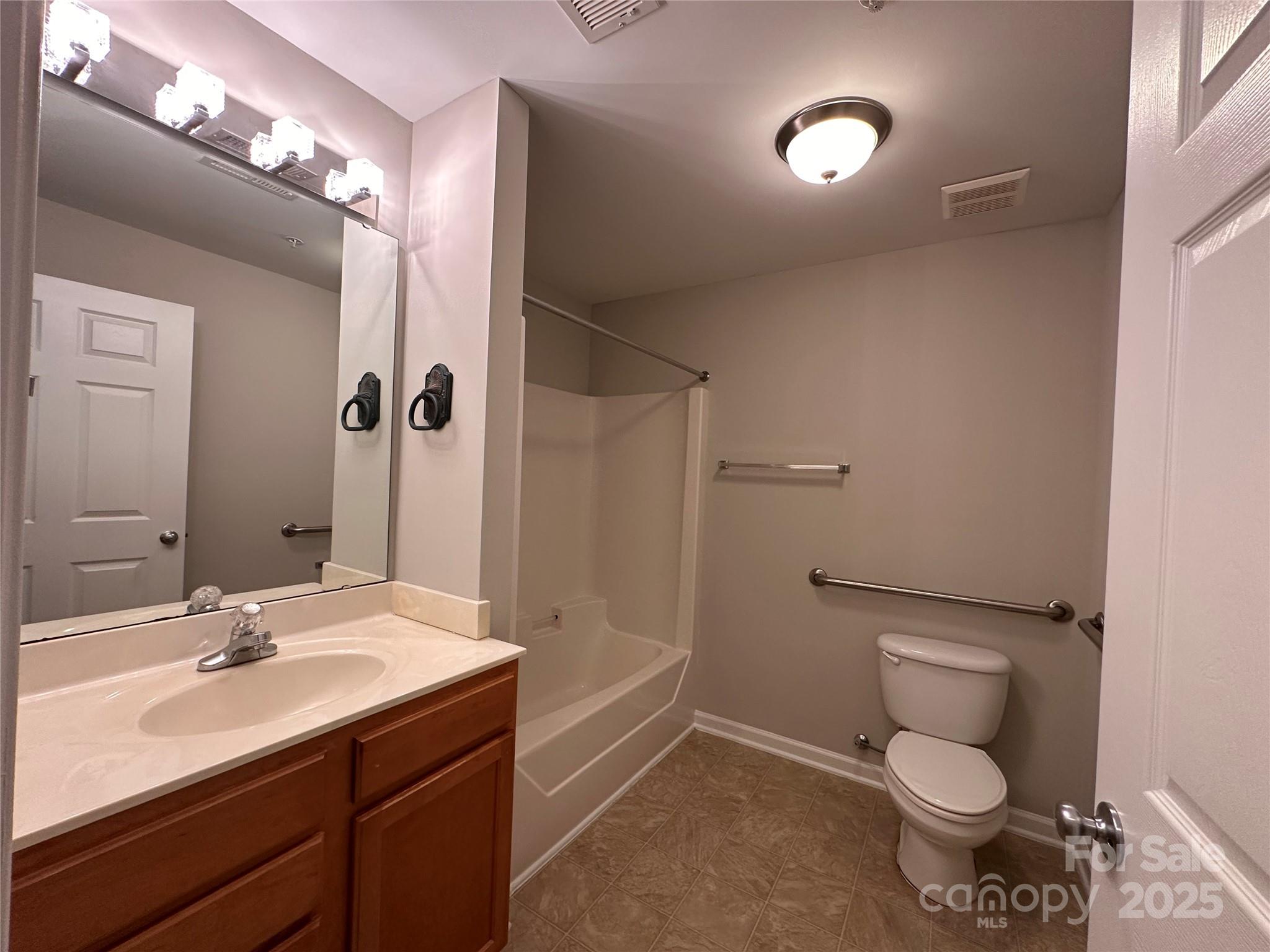 5236 Hilltop Road Jamestown, NC 27282 - Photo 23 of 27 a bathroom with a toilet sink and mirror
