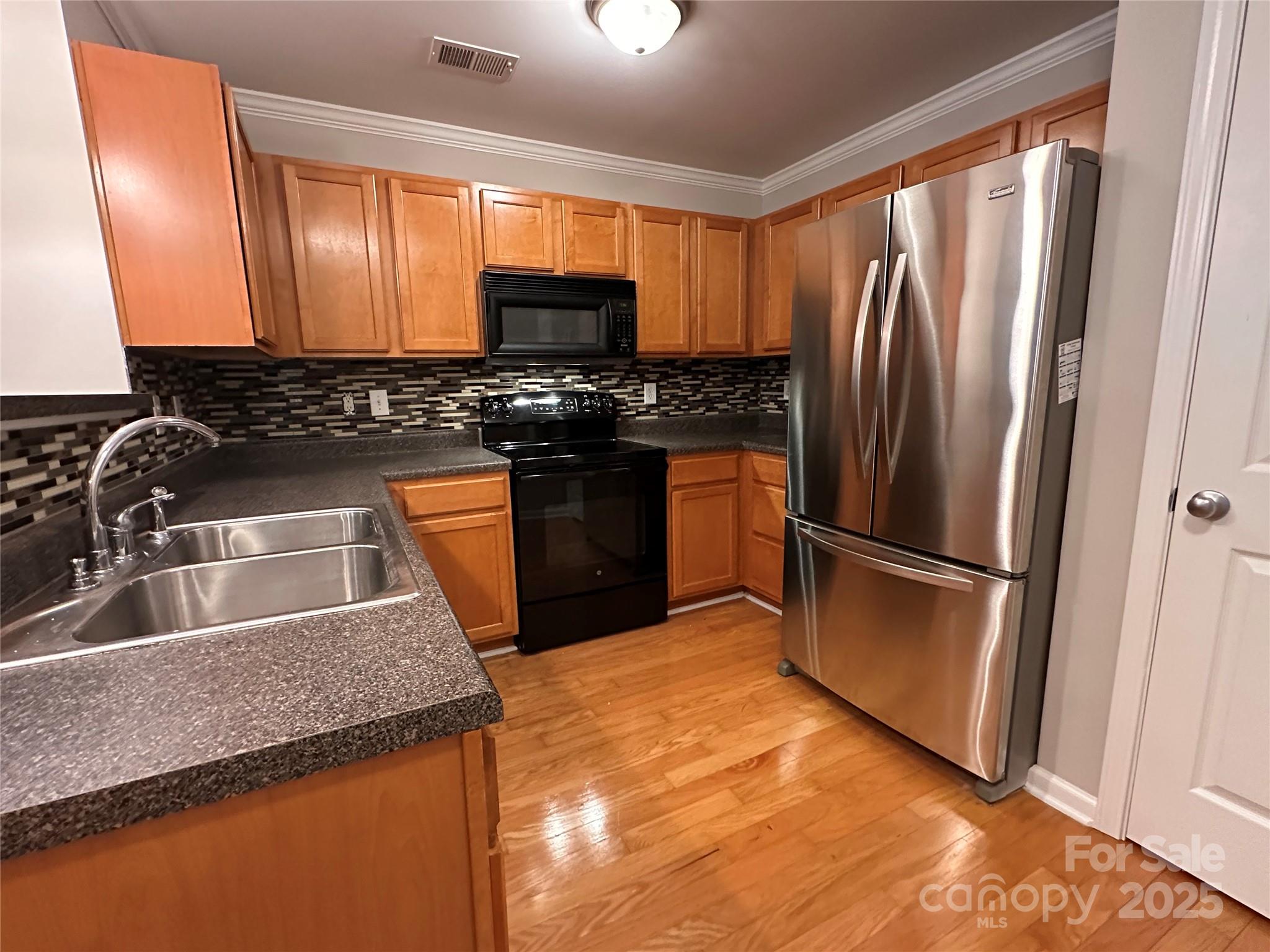 5236 Hilltop Road Jamestown, NC 27282 - Photo 8 of 27 a kitchen with granite countertop a refrigerator and a sink