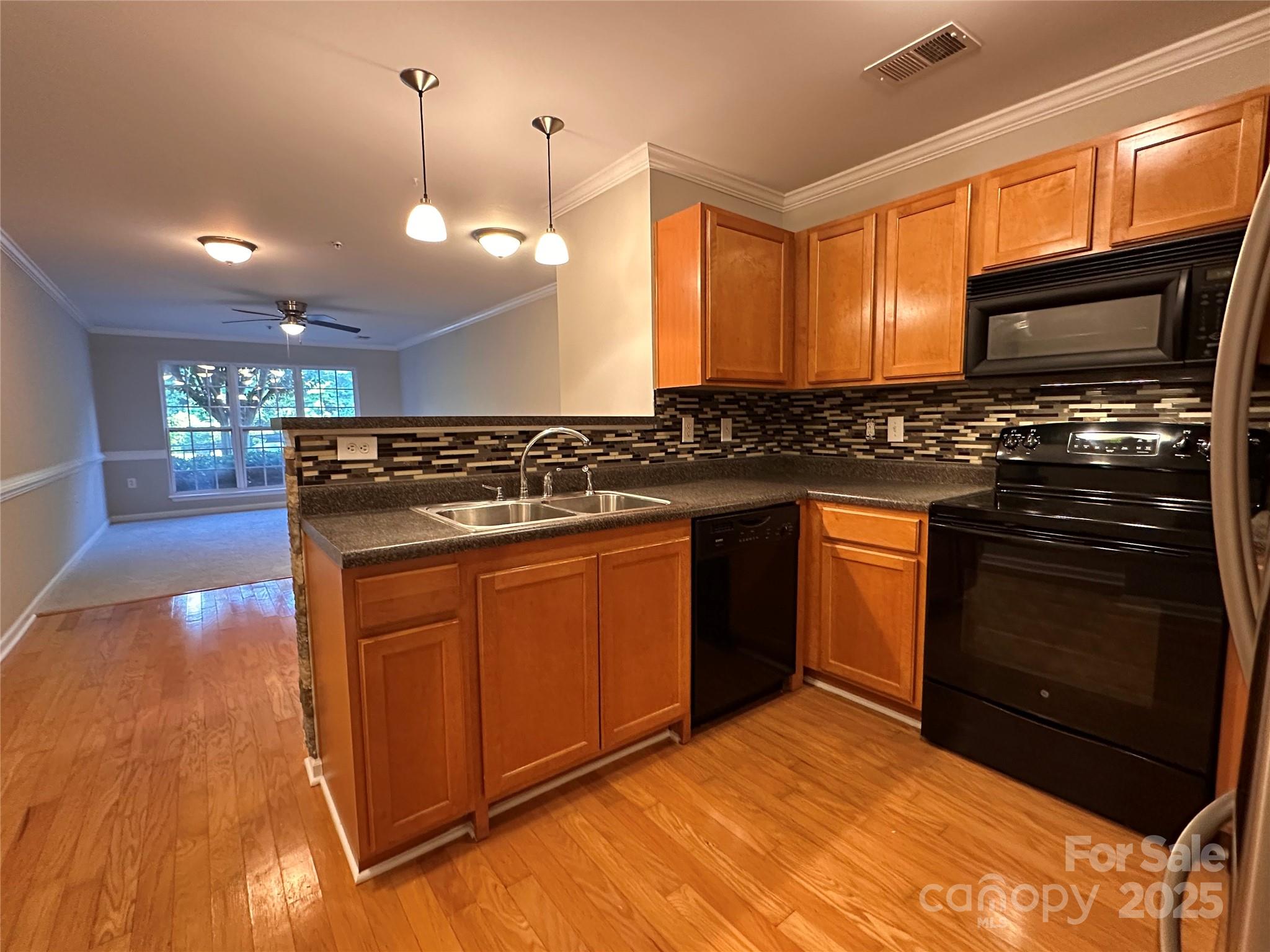 5236 Hilltop Road Jamestown, NC 27282 - Photo 9 of 27 a kitchen with stainless steel appliances granite countertop a stove a sink and a microwave