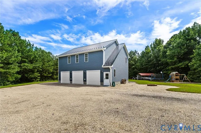 a view of a house with a yard and potted plants