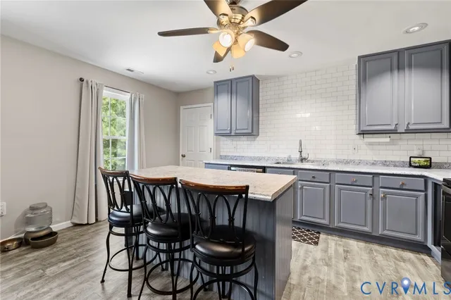 a kitchen with a table chairs sink and cabinets