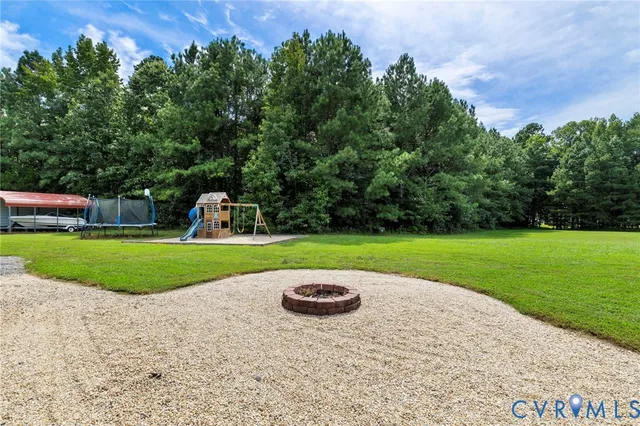 a view of a garden with large trees