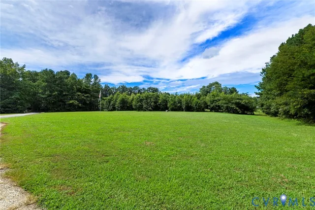 a view of building with green field