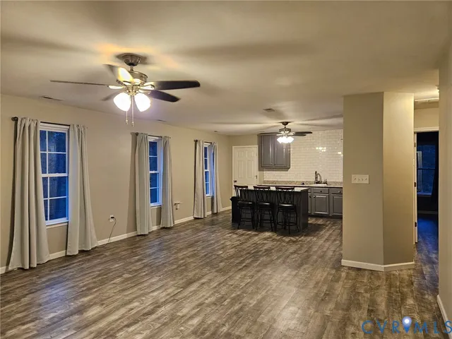 a living room with a couch and a chandelier