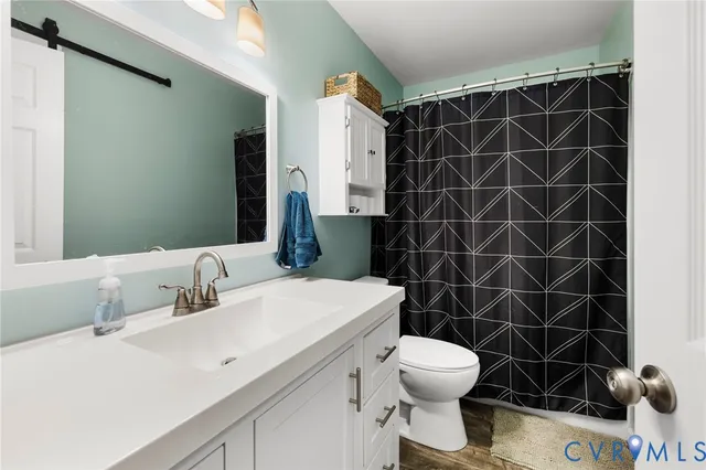 a bathroom with a sink toilet and a mirror