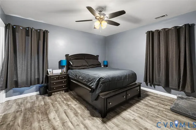 a bedroom with a bed and a ceiling fan