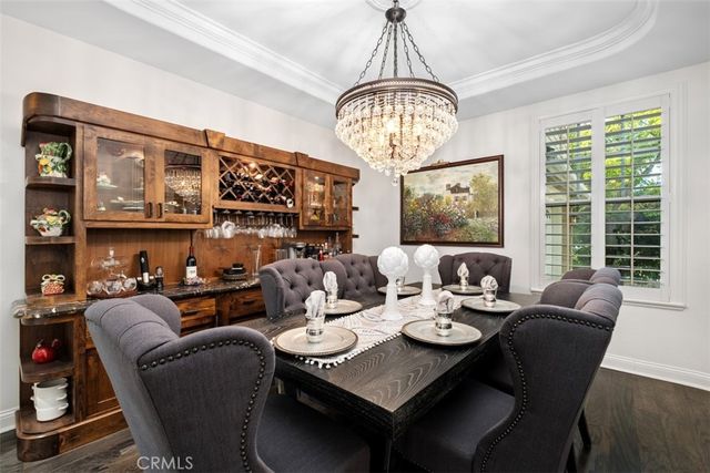 a view of a dining room with furniture wooden floor and chandelier