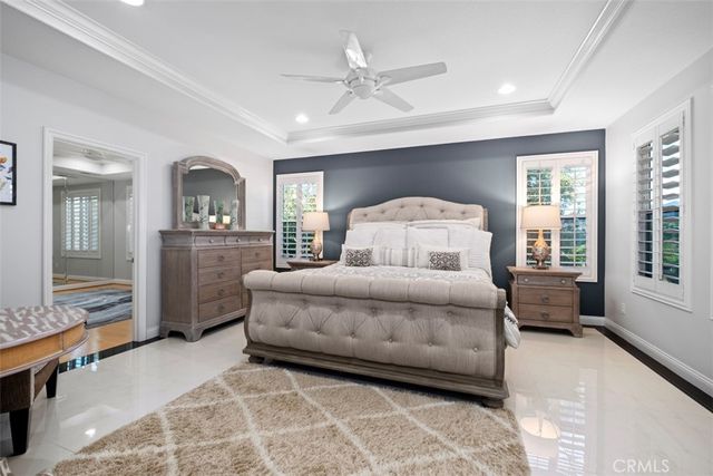 a bedroom with a large bed and a chandelier