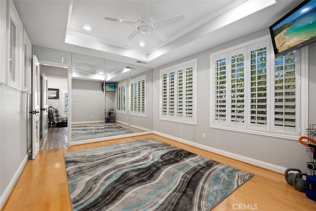 a bed sitting in a spacious bedroom next to a window