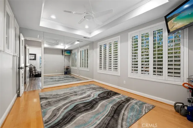 a bed sitting in a spacious bedroom next to a window